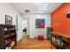 Office with hardwood floors, skylight, and an orange accent wall at 1430 Mount Evans Dr, Longmont, CO 80504