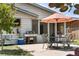Outdoor patio with dining set, grill, and seating area, perfect for entertaining guests in a cozy backyard setting at 1430 Mount Evans Dr, Longmont, CO 80504