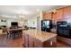 Open-concept kitchen featuring granite countertops, stainless steel appliances, and hardwood floors at 42395 Forest Oaks Dr, Elizabeth, CO 80107