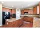 Updated kitchen featuring wood cabinetry, stainless appliances, an island, and granite countertops at 42395 Forest Oaks Dr, Elizabeth, CO 80107