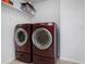 Convenient laundry room with modern red washer and dryer at 42395 Forest Oaks Dr, Elizabeth, CO 80107