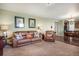 Inviting living room with leather furniture and seamless flow to the adjacent dining area at 42395 Forest Oaks Dr, Elizabeth, CO 80107