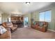 Spacious living room with an open layout, connecting the kitchen and outdoor balcony at 42395 Forest Oaks Dr, Elizabeth, CO 80107