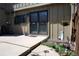 Back patio with sliding glass door and green landscaping at 7920 E Phillips Cir, Centennial, CO 80112