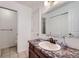 Clean bathroom featuring a modern vanity and door leading to the toilet and shower area at 7920 E Phillips Cir, Centennial, CO 80112
