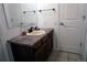 Bathroom vanity with linoleum countertop and dark wood cabinets at 7920 E Phillips Cir, Centennial, CO 80112