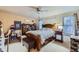 Comfortable bedroom with a queen-sized bed, ceiling fan, and ample natural light at 7920 E Phillips Cir, Centennial, CO 80112