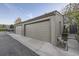 Attached two-car garage with painted doors and an access point to the house's entrance at 7920 E Phillips Cir, Centennial, CO 80112