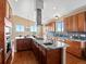 Gourmet kitchen featuring granite countertops, stainless steel appliances, and a large island with cooktop and sink at 14077 Indianfield Ct, Hudson, CO 80642