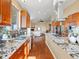 Open kitchen with stainless steel appliances, granite countertops, island cooktop, and view into the living room at 14077 Indianfield Ct, Hudson, CO 80642