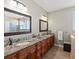 Luxurious main bathroom with dual vanities, granite countertops, and a glass-enclosed shower for a spa-like experience at 14077 Indianfield Ct, Hudson, CO 80642