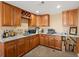 Basement wet bar area with granite countertops and wooden cabinets at 14077 Indianfield Ct, Hudson, CO 80642