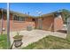 Brick home exterior with patio and satellite dish overlooking the backyard at 717 E 4Th Ave, Longmont, CO 80504