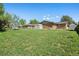 Large backyard with shed, brick house and green grass at 717 E 4Th Ave, Longmont, CO 80504