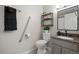 Bright bathroom with granite vanity, shelving and safety bars installed for easy access at 717 E 4Th Ave, Longmont, CO 80504
