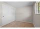 Carpeted bedroom with a sliding door closet and a window providing natural light at 717 E 4Th Ave, Longmont, CO 80504
