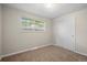 Bright bedroom features carpet, natural light, and a sliding door closet at 717 E 4Th Ave, Longmont, CO 80504