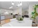 Bright kitchen with stainless steel appliances and hardwood floors, flowing into a dining area at 717 E 4Th Ave, Longmont, CO 80504