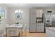 Dining area showcasing cabinetry, stainless steel refrigerator, and hardwood floors at 717 E 4Th Ave, Longmont, CO 80504