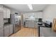 Bright kitchen with stainless steel appliances and hardwood floors at 717 E 4Th Ave, Longmont, CO 80504