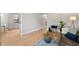 Open-concept living space with hardwood floors, stylish decor, and access to the kitchen at 717 E 4Th Ave, Longmont, CO 80504