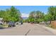 A quiet tree-lined street showcases the neighborhood with mountain views in the distance at 717 E 4Th Ave, Longmont, CO 80504