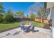Backyard featuring a patio with outdoor seating and lush lawn surrounded by a wooden fence at 8004 S Field St, Littleton, CO 80128