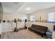 A versatile basement space with a neutral carpet, futon, and weight training equipment at 8004 S Field St, Littleton, CO 80128