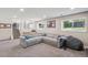 Finished basement with carpet, a sectional sofa, and large windows at 8004 S Field St, Littleton, CO 80128