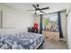 Bright bedroom featuring a ceiling fan, a window with blue curtains, and neutral walls at 8004 S Field St, Littleton, CO 80128