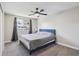 Bedroom with a blue bed frame, gray bedding, neutral walls, and a ceiling fan at 8004 S Field St, Littleton, CO 80128