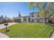 Charming two-story home boasts fresh landscaping and a large, well-maintained front lawn at 8004 S Field St, Littleton, CO 80128