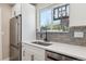 Modern kitchen with white cabinets, stainless steel appliances and hardwood floors at 8004 S Field St, Littleton, CO 80128