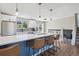Modern kitchen features a breakfast bar, white cabinets, stainless steel appliances and hardwood floors at 8004 S Field St, Littleton, CO 80128