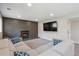 Comfortable living room featuring a brick fireplace, a large TV, and a sectional sofa at 8004 S Field St, Littleton, CO 80128