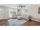 Bright and airy living room featuring hardwood floors, a comfortable sectional sofa, and natural light at 8004 S Field St, Littleton, CO 80128