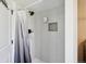 Modern shower with light gray tiles, a shower head, and a built-in niche at 8004 S Field St, Littleton, CO 80128