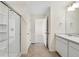 Well-lit bathroom features tile flooring, a glass shower, and a vanity with a wide mirror at 17949 Dandy Brush Ln, Parker, CO 80134