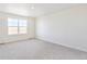 Bright bedroom with neutral carpet, a large window for natural light, and ample space for furniture at 17949 Dandy Brush Ln, Parker, CO 80134