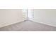 Bright bedroom features a window, carpeted floors, a door, and white trim and walls at 17949 Dandy Brush Ln, Parker, CO 80134
