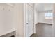 Bright entryway featuring coat hooks, a bench, and wood-look floors at 17949 Dandy Brush Ln, Parker, CO 80134