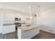 Bright kitchen features white cabinets, stainless steel appliances, and a spacious island with granite countertops at 17949 Dandy Brush Ln, Parker, CO 80134