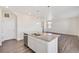 Open-concept kitchen with a spacious island, granite countertops, and stainless-steel appliances flows seamlessly into the living area at 17949 Dandy Brush Ln, Parker, CO 80134