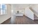 Open-concept living area with wood-look floors and natural light at 17949 Dandy Brush Ln, Parker, CO 80134