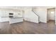 Open-concept living area with wood-look floors and a kitchen island at 17949 Dandy Brush Ln, Parker, CO 80134