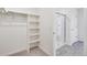 Spacious walk-in closet features carpeted floors, shelving and a sturdy clothing rack at 17949 Dandy Brush Ln, Parker, CO 80134
