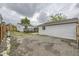 Spacious backyard with a detached garage and wooden fence, providing privacy at 1680 Simms St, Lakewood, CO 80215