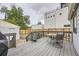 Spacious backyard with a wooden deck, perfect for outdoor dining and relaxation, complemented by lush greenery at 1680 Simms St, Lakewood, CO 80215