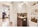 Compact bathroom showcasing a vanity with storage, neutral tiling, and a toilet accessorized with greenery and wall art at 1680 Simms St, Lakewood, CO 80215