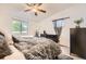 Comfortable bedroom with a ceiling fan, natural light, and neutral decor at 1680 Simms St, Lakewood, CO 80215